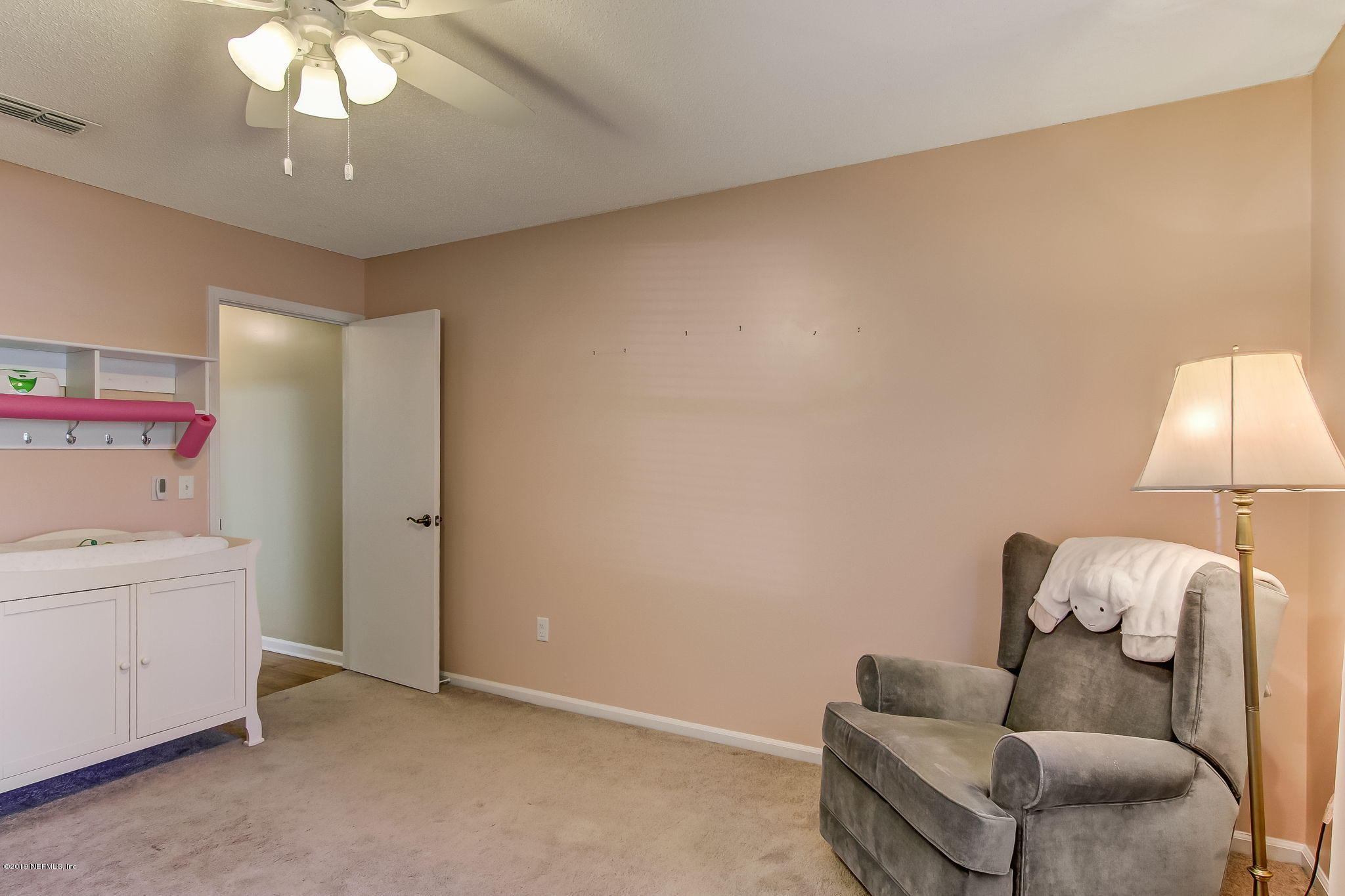 11060 Reading Road Jacksonville, FL 32257 - Photo 30 of 43 a living room with furniture and a baby crib