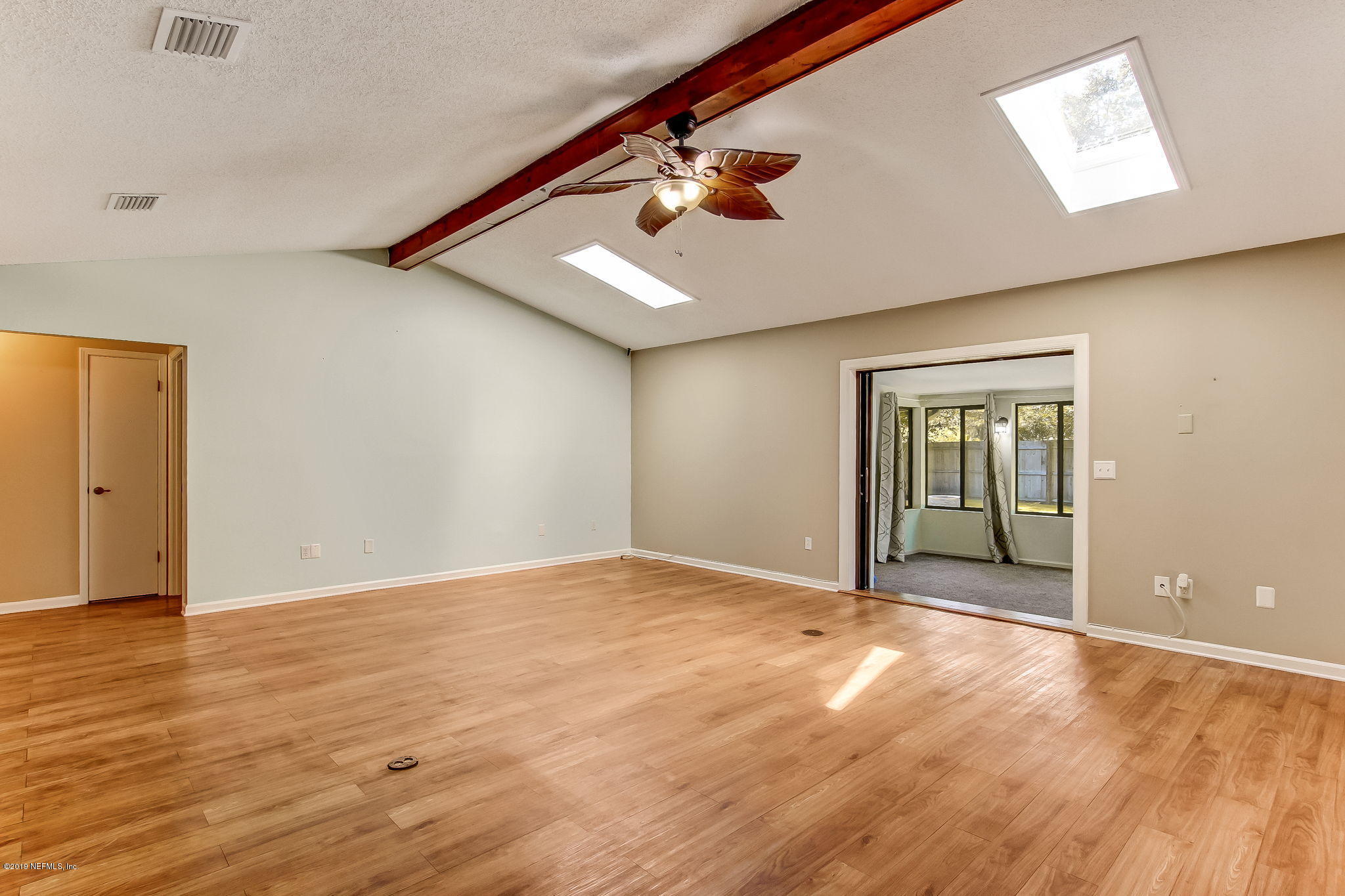 11060 Reading Road Jacksonville, FL 32257 - Photo 9 of 43 a view of an empty room with wooden floor and a window