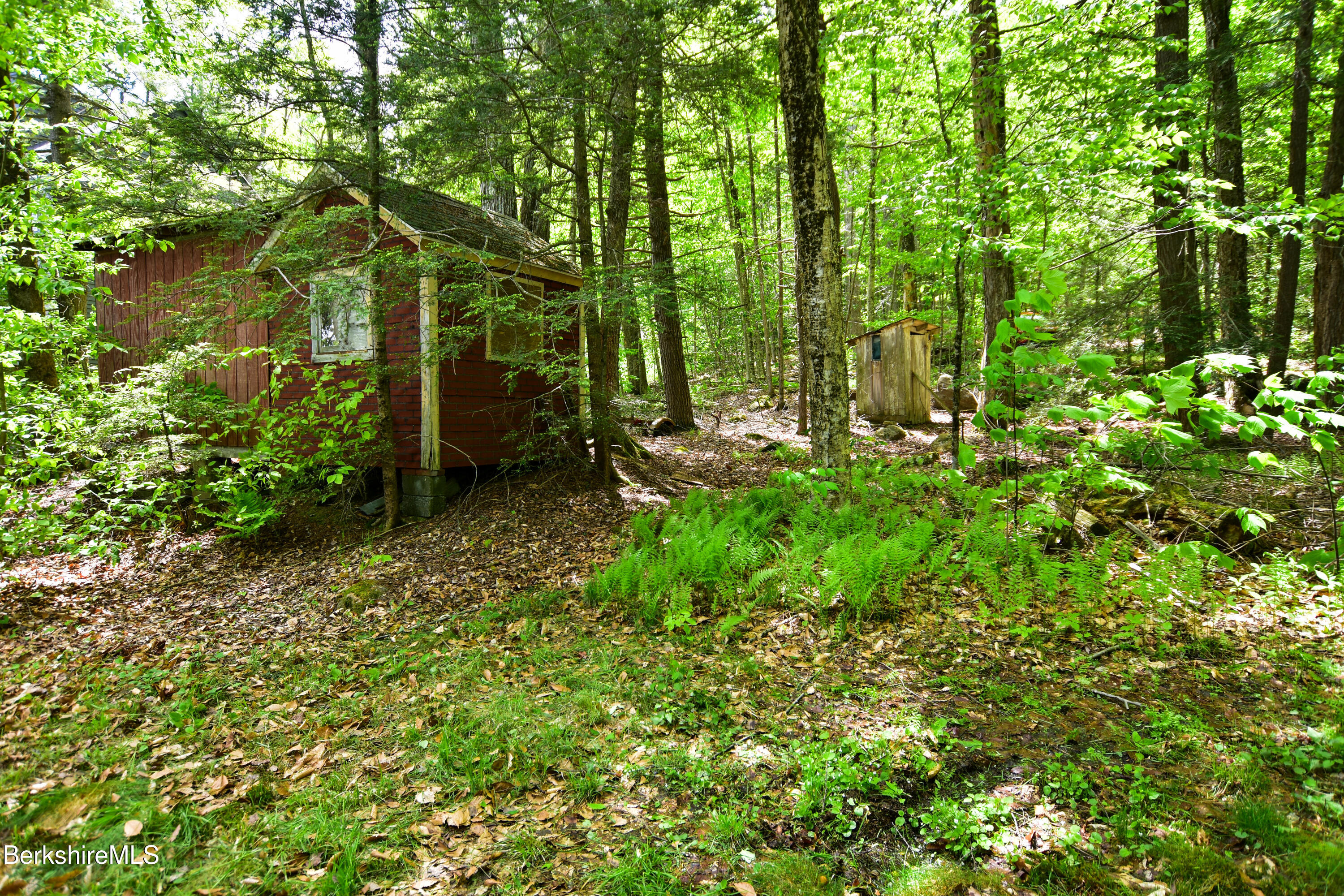18 Osceola Road Becket, MA 01223 - Photo 17 of 19 a backyard of a house with lots of green space and a fountain