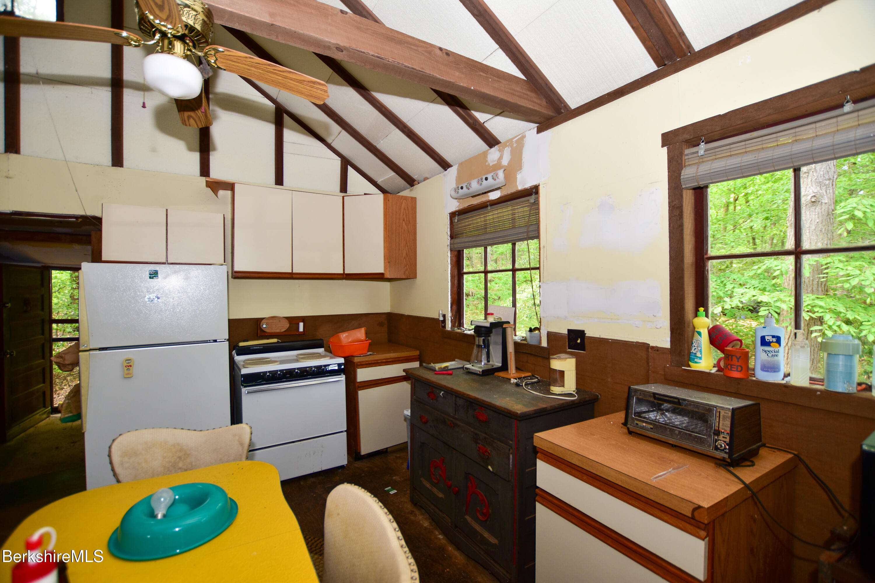 18 Osceola Road Becket, MA 01223 - Photo 8 of 19 a kitchen with a refrigerator a stove a sink dishwasher and white countertops with wooden floor