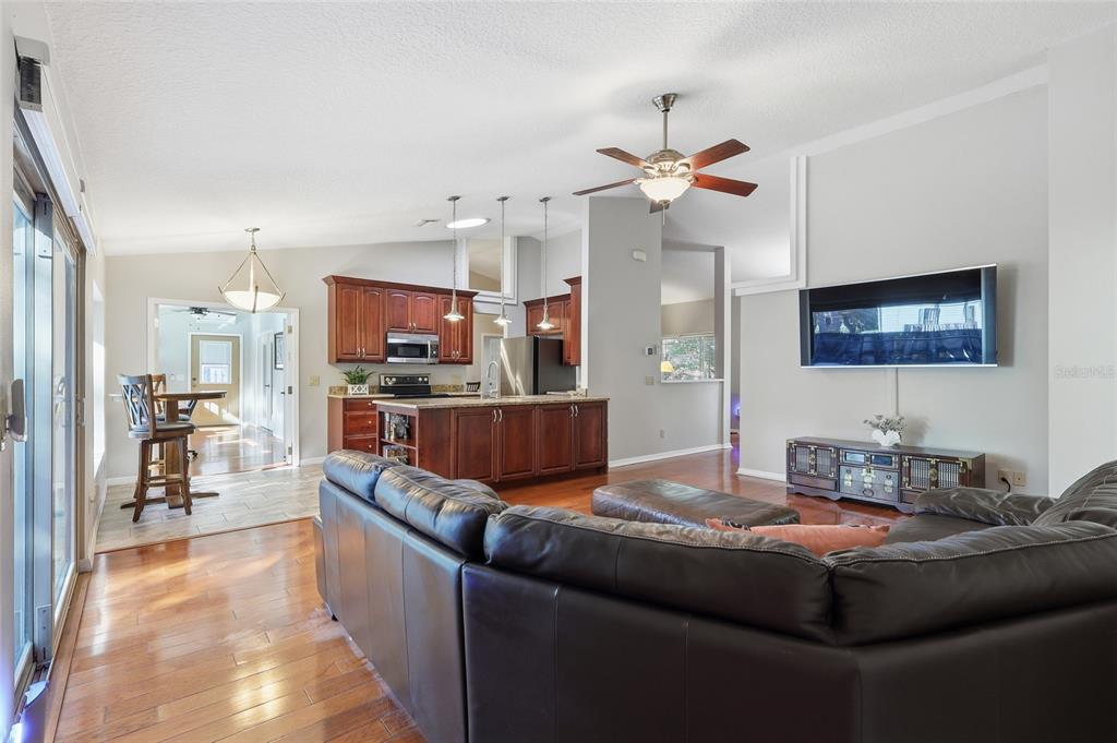 3488 Ridge Boulevard Palm Harbor, FL 34684 - Photo 7 of 30 a living room with stainless steel appliances kitchen island granite countertop furniture and a view of kitchen