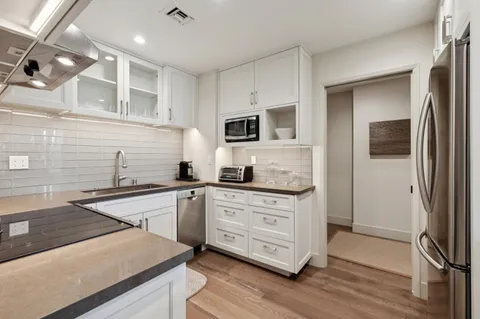 a kitchen with a sink stove and refrigerator