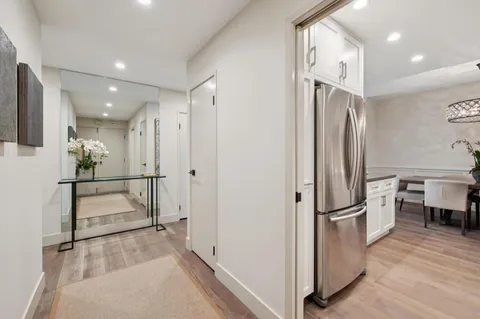 a view of kitchen with furniture and refrigerator