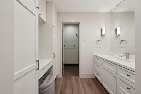 a bathroom with a double vanity sink a mirror and a shower