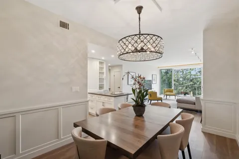 a view of a dining room with furniture wooden floor and chandelier