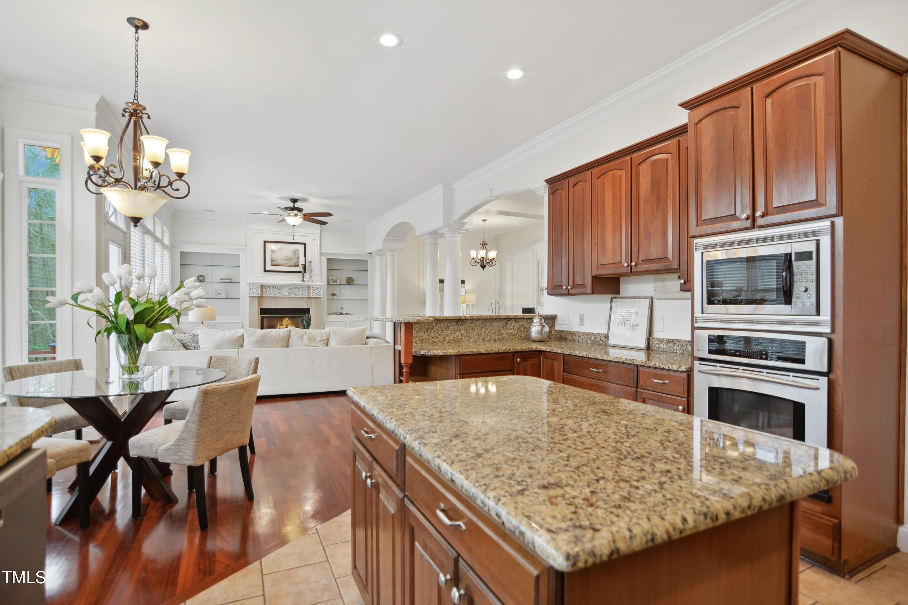 3101 Shinleaf Court Raleigh, NC 27613 - Photo 15 of 44 a kitchen with stainless steel appliances granite countertop a table chairs and a refrigerator