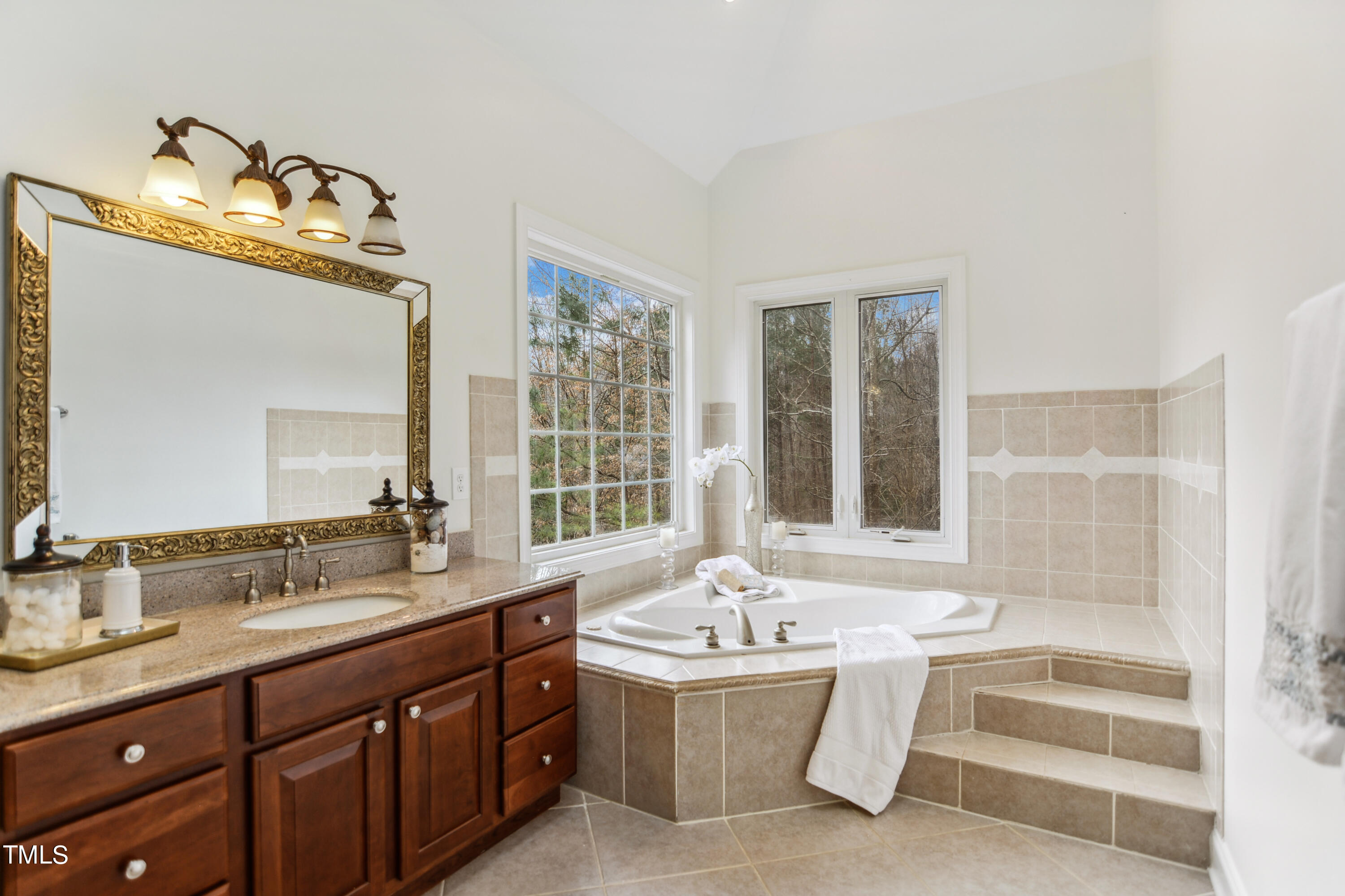 3101 Shinleaf Court Raleigh, NC 27613 - Photo 21 of 44 a bathroom with a tub sink and mirror