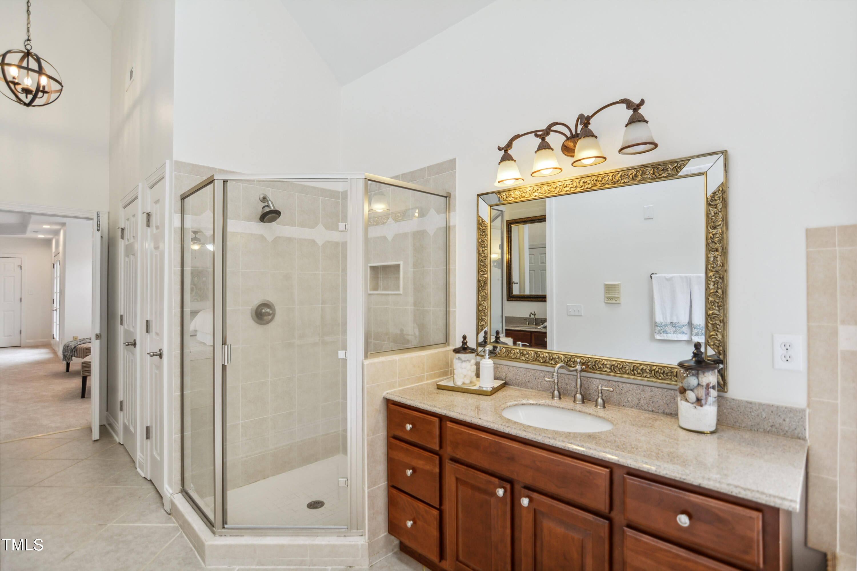 3101 Shinleaf Court Raleigh, NC 27613 - Photo 22 of 44 a bathroom with a granite countertop sink mirror and shower