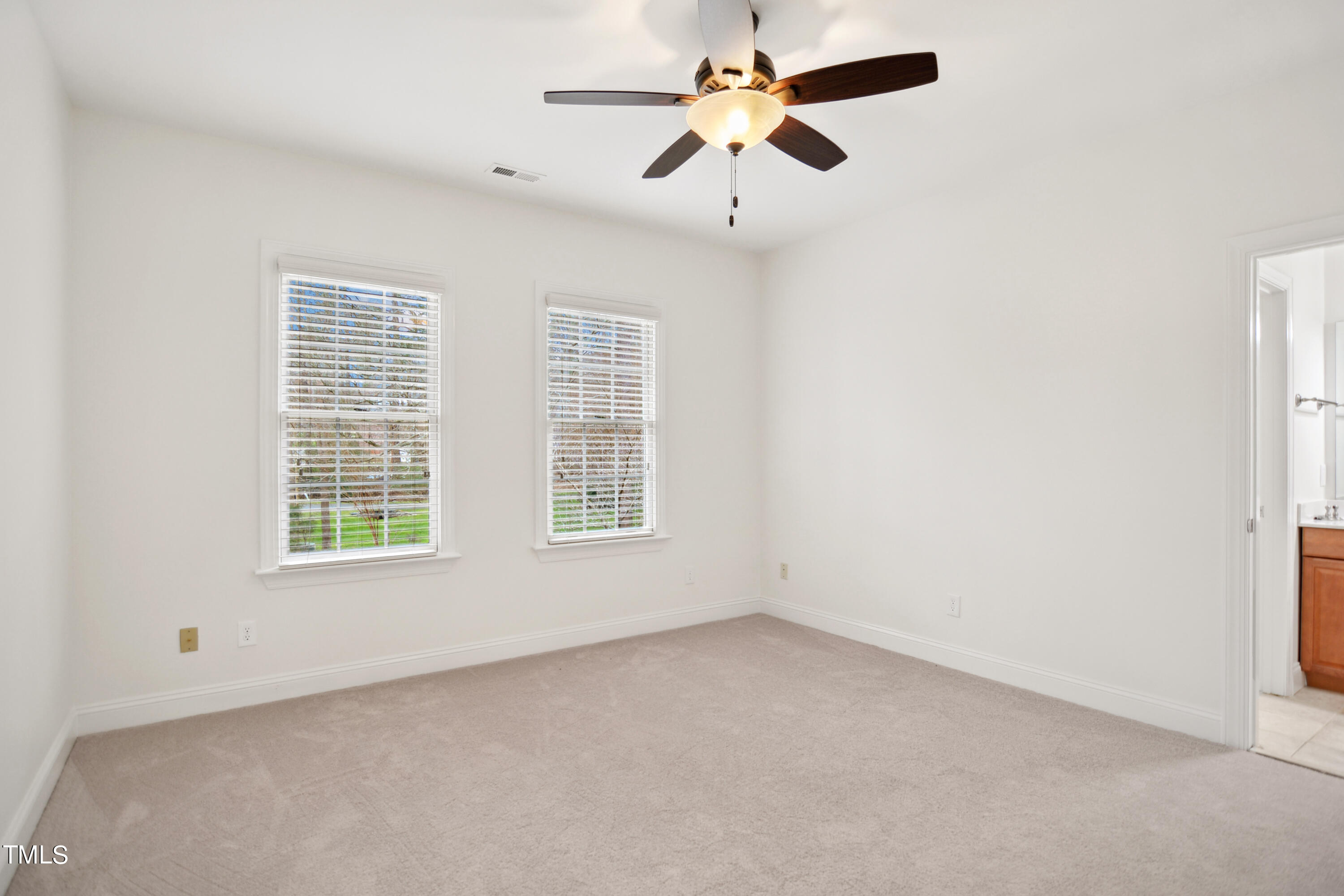 3101 Shinleaf Court Raleigh, NC 27613 - Photo 27 of 44 an empty room with a window and a fan