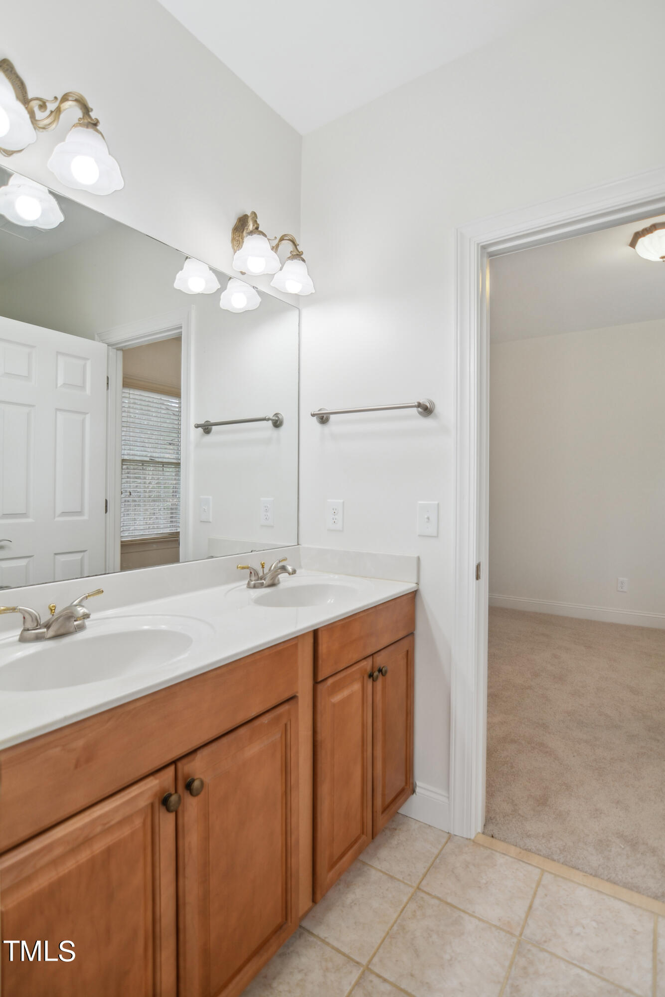 3101 Shinleaf Court Raleigh, NC 27613 - Photo 28 of 44 a bathroom with a sink and a mirror