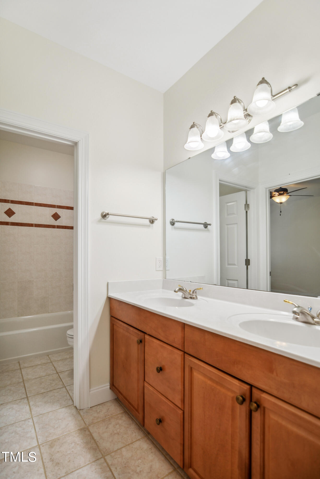3101 Shinleaf Court Raleigh, NC 27613 - Photo 30 of 44 a bathroom with a granite countertop sink a toilet and a mirror