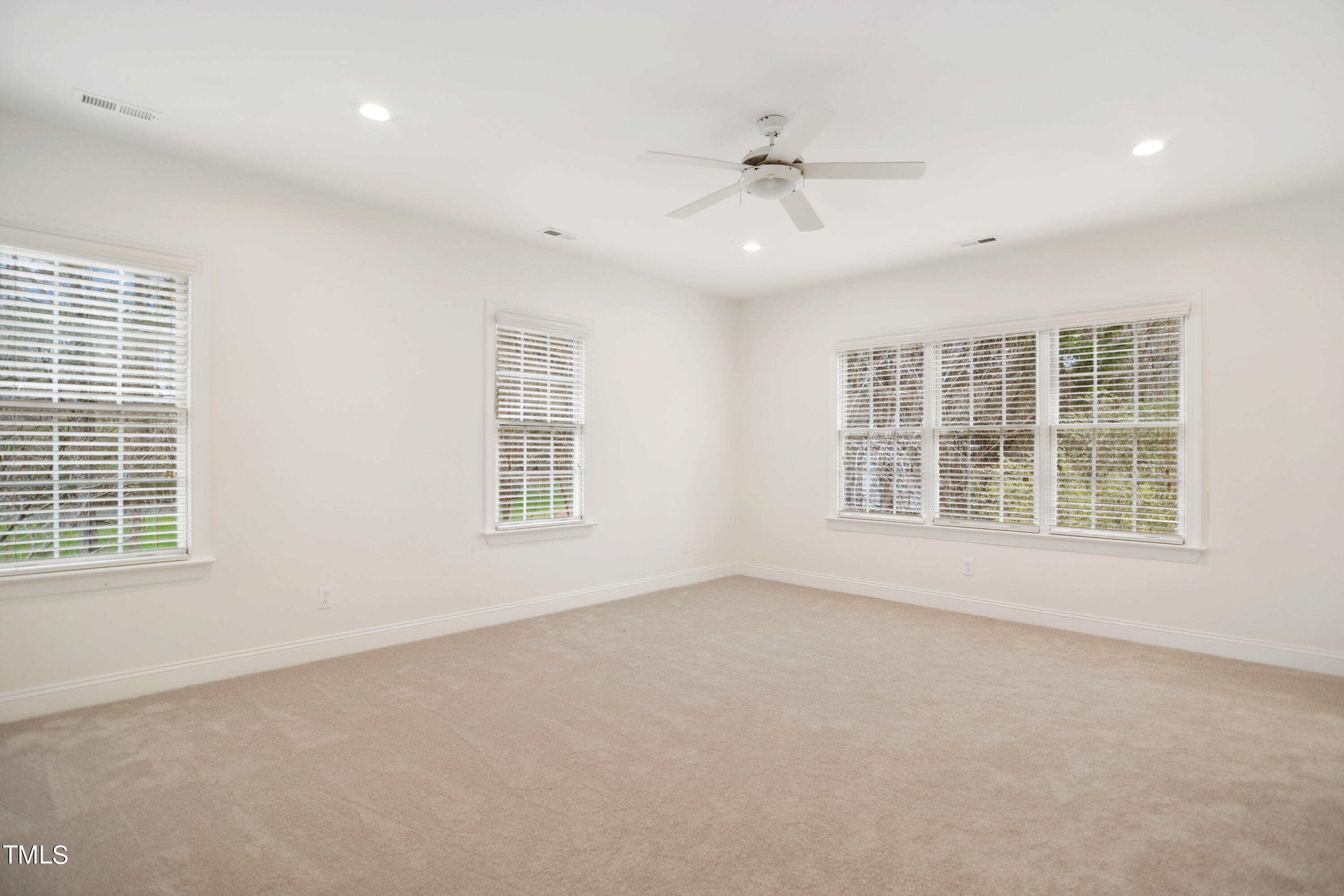 3101 Shinleaf Court Raleigh, NC 27613 - Photo 32 of 44 an empty room with a window and a ceiling fan