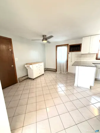 a spacious bathroom with a mirror and tiles flooring