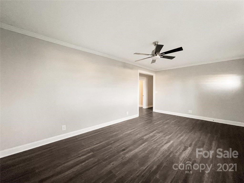 235 Porter Road Rock Hill, SC 29730 - Photo 18 of 29 a view of wooden floor and a chandelier fan in an empty room