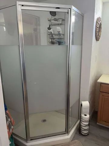 a bathroom with a shower and closet