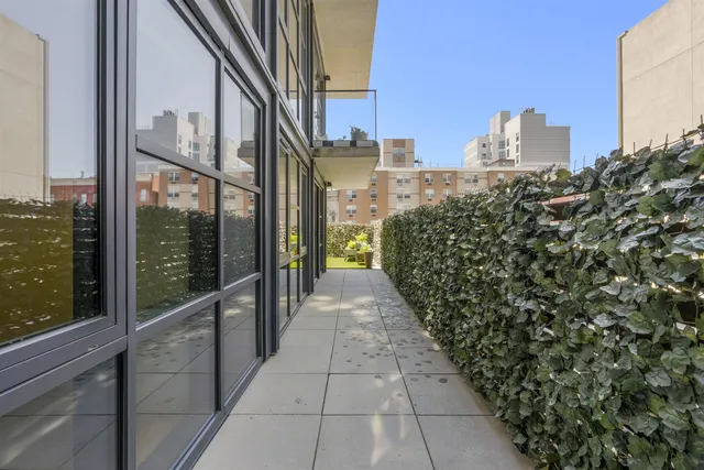 a front view of a building with a garden