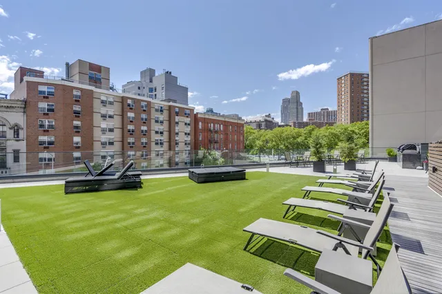 a living room with patio furniture and a chandelier