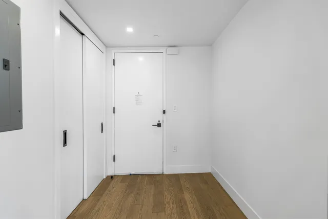 a large open kitchen with granite countertop a large window and stainless steel appliances