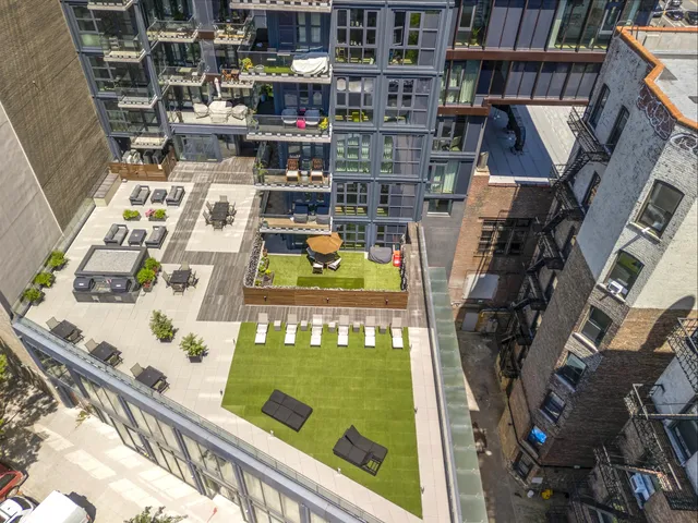 a large kitchen with stainless steel appliances a sink and a stove
