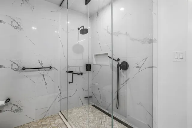 a bathroom with a double vanity sink mirror and shower