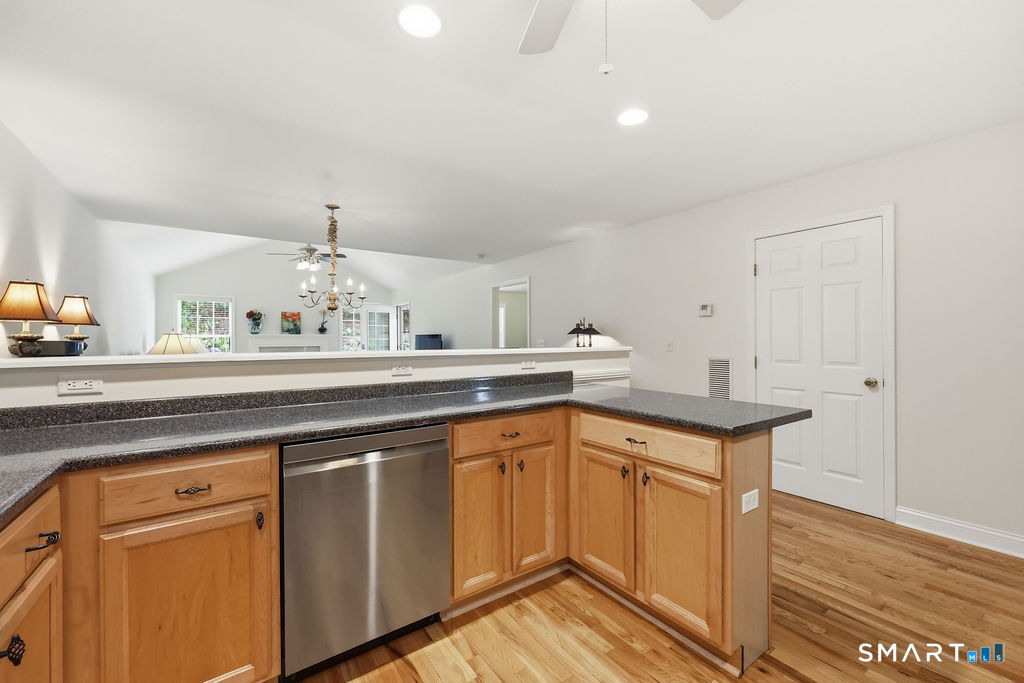 98 Haley Lane, Unit 98 Newtown, CT 06482 - Photo 13 of 33 a kitchen with a sink cabinets and wooden floor