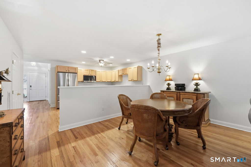 98 Haley Lane, Unit 98 Newtown, CT 06482 - Photo 15 of 33 a view of a dining room with furniture and wooden floor