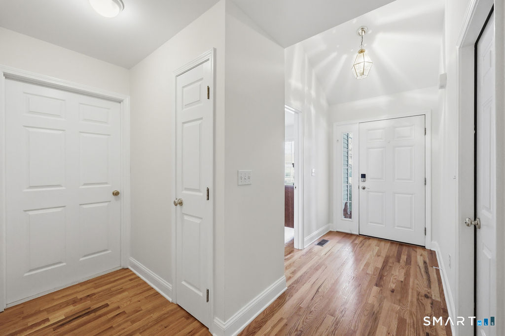 98 Haley Lane, Unit 98 Newtown, CT 06482 - Photo 16 of 33 a view of a hallway with wooden floor and closet area