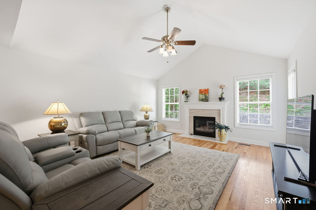 98 Haley Lane, Unit 98 Newtown, CT 06482 - Photo 17 of 33 a living room with furniture and a fireplace