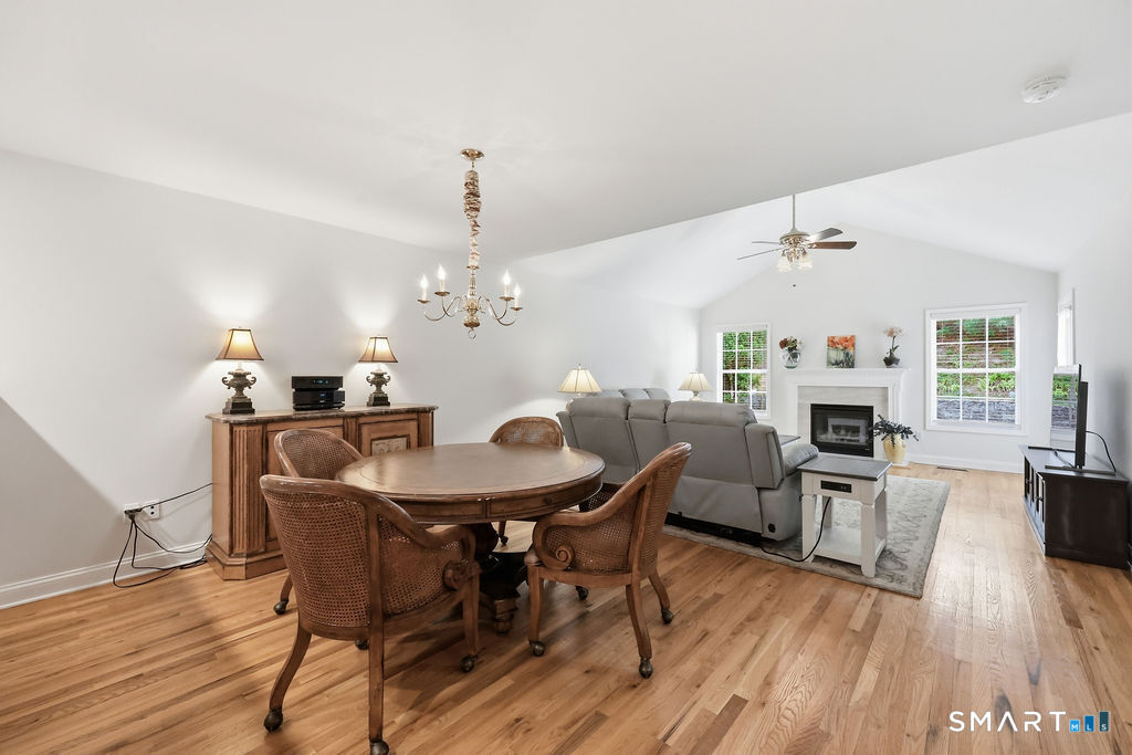 98 Haley Lane, Unit 98 Newtown, CT 06482 - Photo 18 of 33 a view of a dining room with furniture window and wooden floor