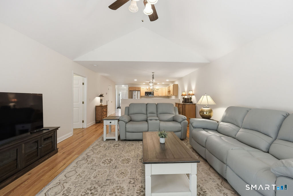 98 Haley Lane, Unit 98 Newtown, CT 06482 - Photo 20 of 33 a living room with furniture and a flat screen tv
