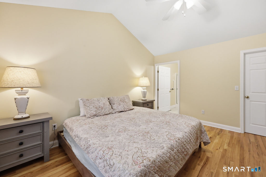 98 Haley Lane, Unit 98 Newtown, CT 06482 - Photo 25 of 33 a bedroom with a bed and a lamp on table