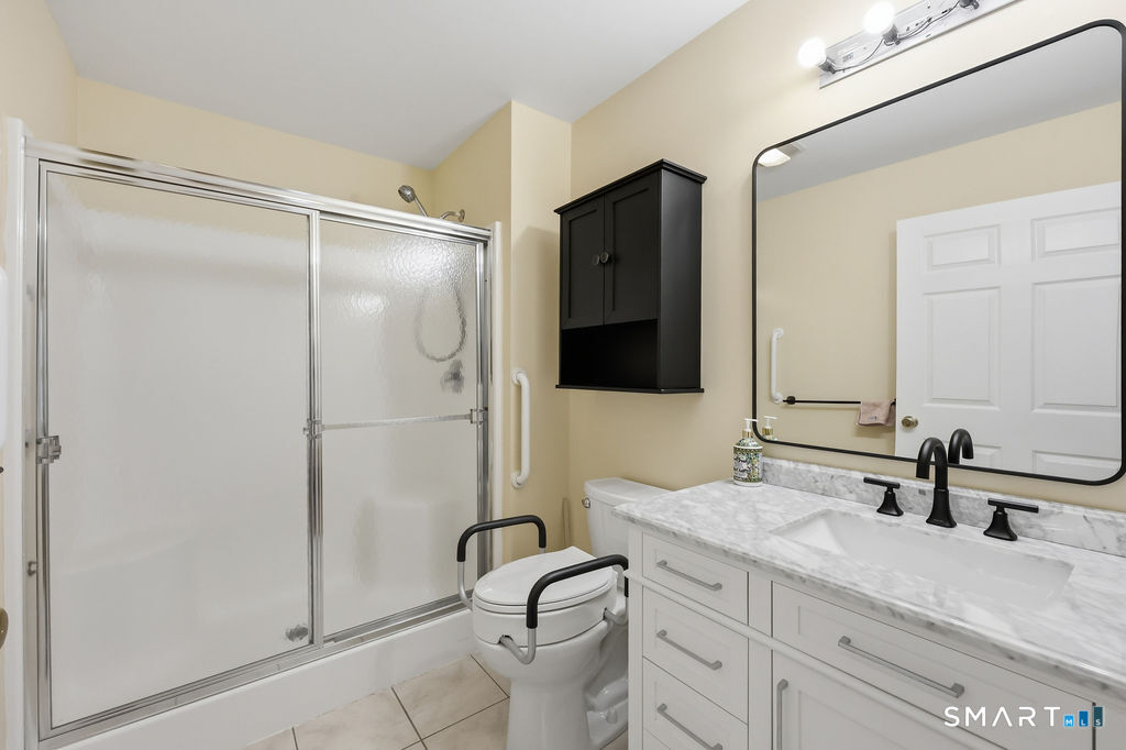 98 Haley Lane, Unit 98 Newtown, CT 06482 - Photo 26 of 33 a bathroom with a granite countertop sink toilet and shower