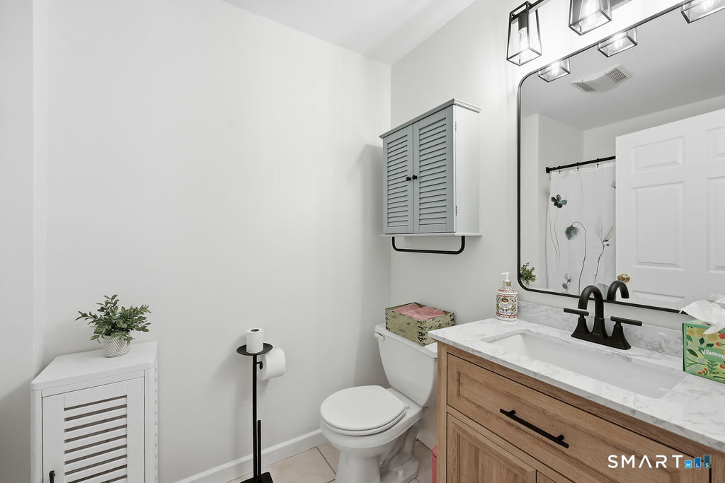 98 Haley Lane, Unit 98 Newtown, CT 06482 - Photo 27 of 33 a bathroom with a sink a toilet and mirror