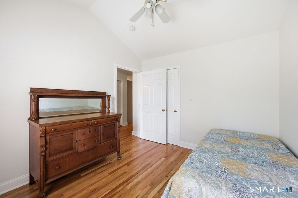 98 Haley Lane, Unit 98 Newtown, CT 06482 - Photo 28 of 33 a room with a dresser and a chandelier