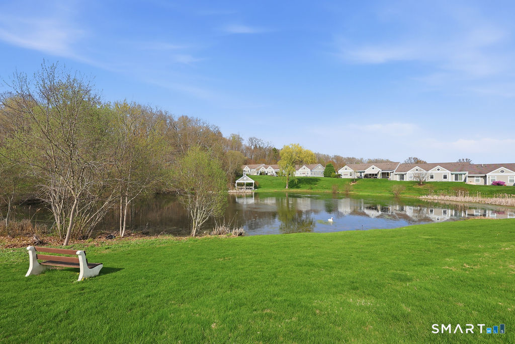 98 Haley Lane, Unit 98 Newtown, CT 06482 - Photo 3 of 33 a view of a lake with a house in the background