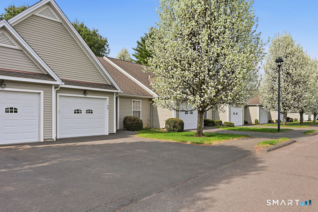 98 Haley Lane, Unit 98 Newtown, CT 06482 - Photo 5 of 33 a front view of a house with a yard and trees