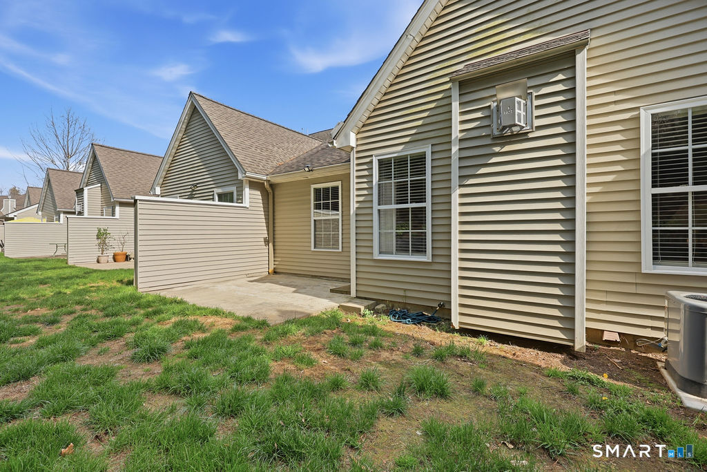 98 Haley Lane, Unit 98 Newtown, CT 06482 - Photo 9 of 33 a view of a house with a yard and garage