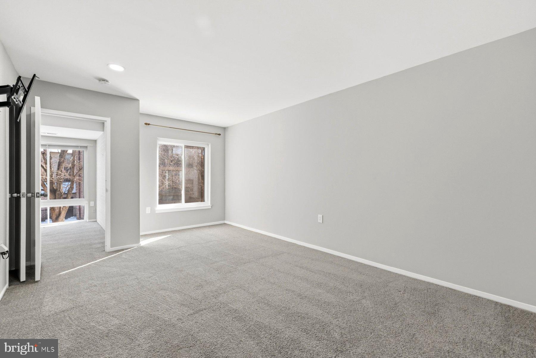 10026 Stedwick Road, Unit 201 Gaithersburg, MD 20886 - Photo 19 of 25 Spacious, light-filled room with serene views.