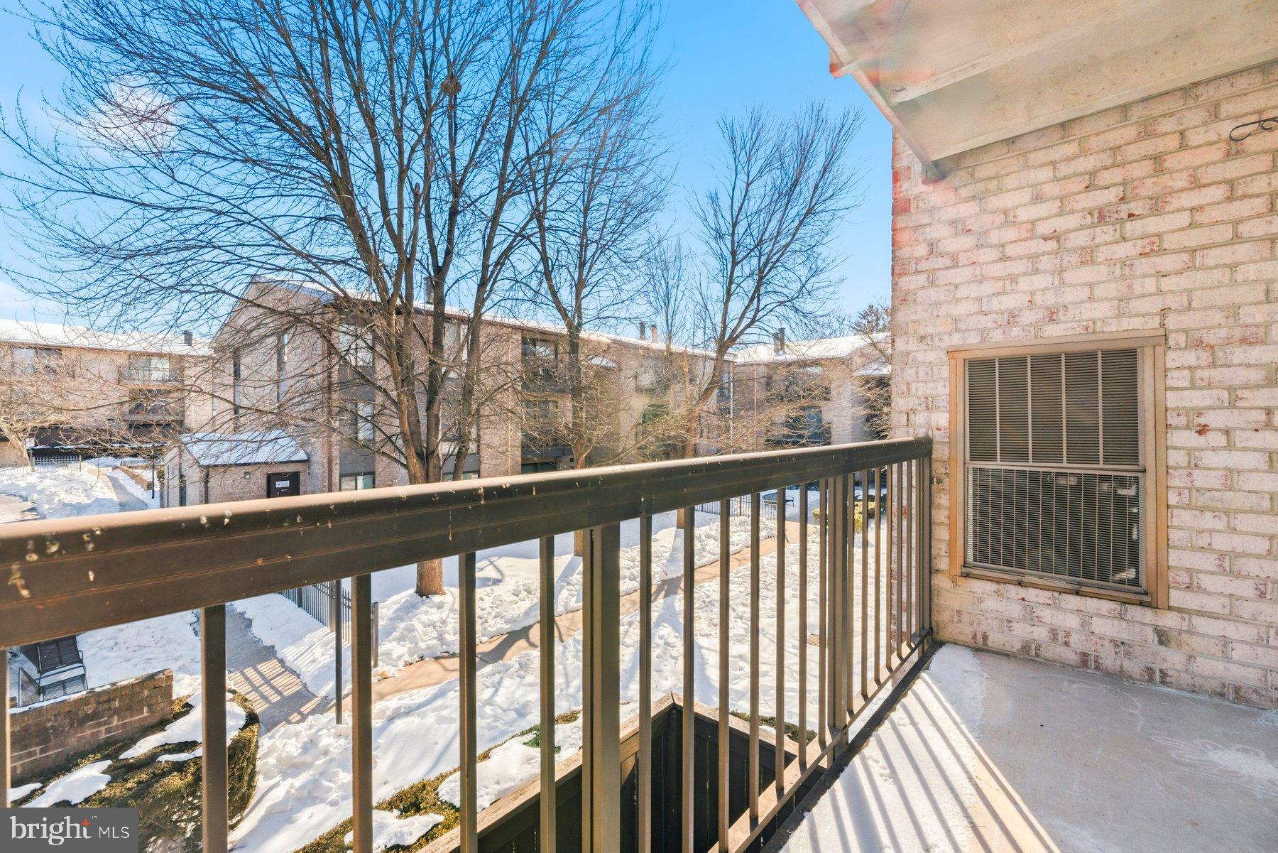 10026 Stedwick Road, Unit 201 Gaithersburg, MD 20886 - Photo 24 of 25 Sunny balcony view overlooking winter landscape.