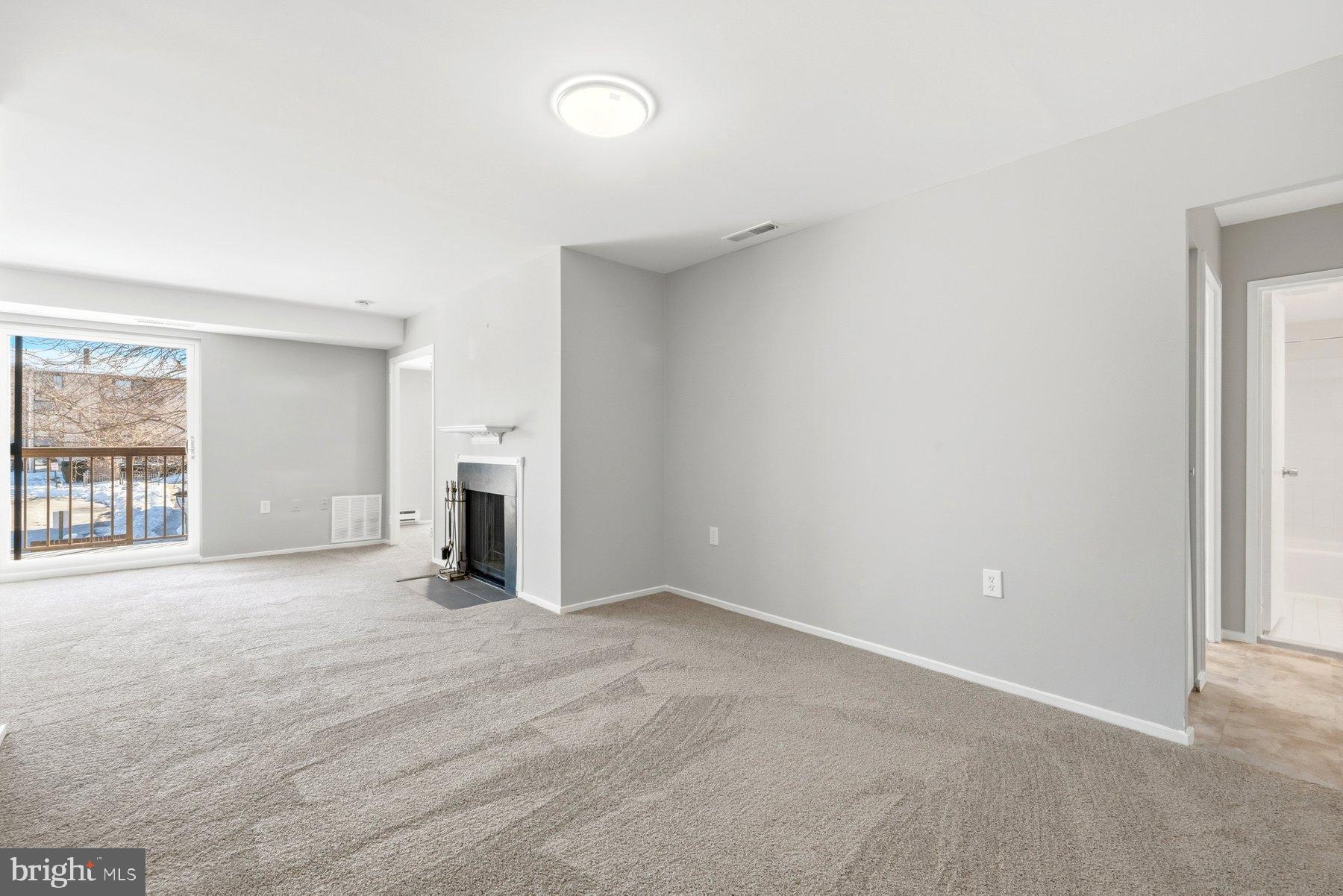 10026 Stedwick Road, Unit 201 Gaithersburg, MD 20886 - Photo 4 of 25 Spacious, light-filled living area awaits you.