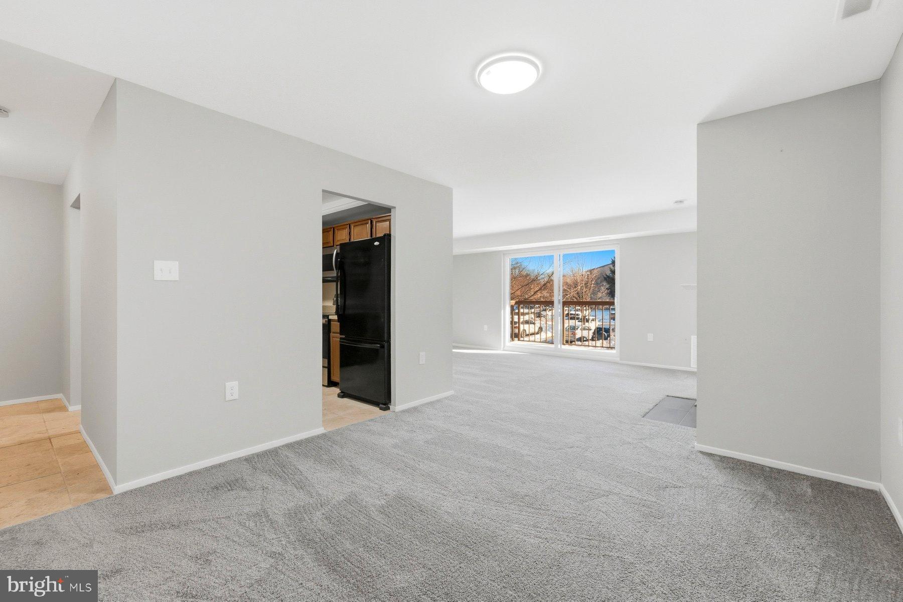 10026 Stedwick Road, Unit 201 Gaithersburg, MD 20886 - Photo 5 of 25 Spacious, light-filled living area awaits you.