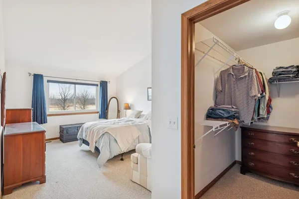 a view of bedroom with furniture and large window