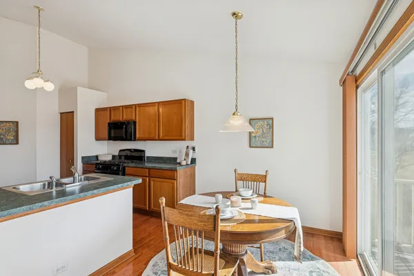 a kitchen with stainless steel appliances kitchen island granite countertop a sink and a granite counter tops