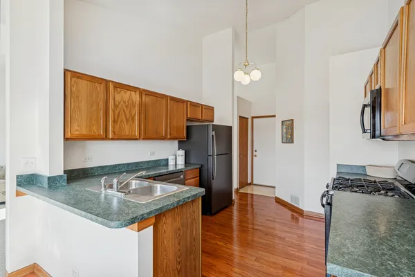 a kitchen with stainless steel appliances granite countertop a sink refrigerator and microwave