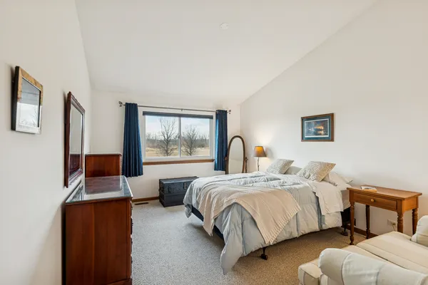 a bedroom with two beds and a large window