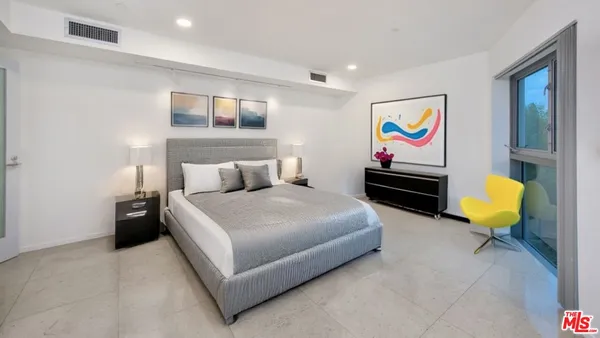 a bedroom with furniture and wooden floor