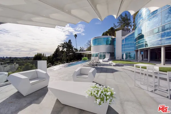 a living room with patio furniture and a floor to ceiling window