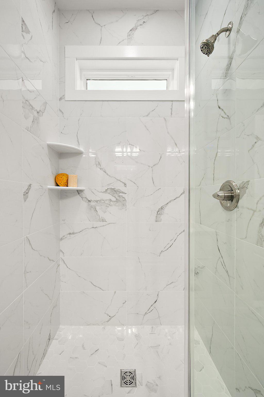 36022 Jackson Street Ocean View, DE 19970 - Photo 26 of 50 Sleek marble shower with natural light.