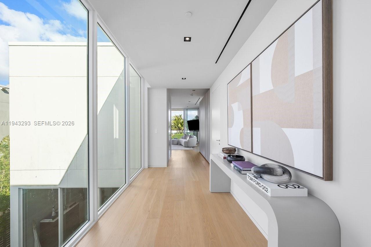 1011 West 48th Street Miami Beach, FL 33140 - Photo 17 of 44 a view of a hallway with furniture and floor to ceiling window