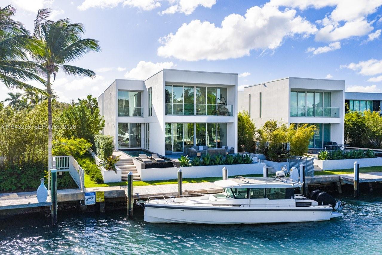 1011 West 48th Street Miami Beach, FL 33140 - Photo 2 of 44 a view of a house with swimming pool and sitting area